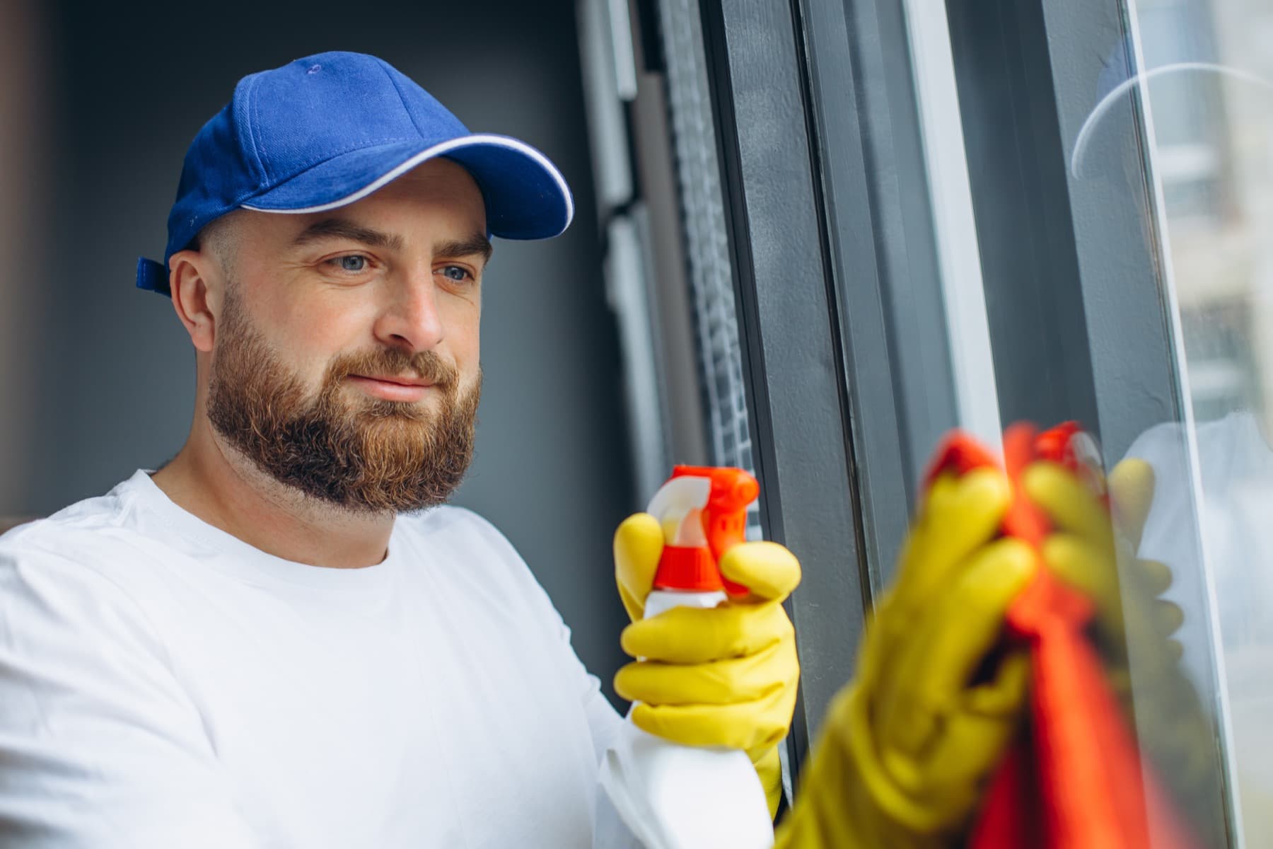 Cleaner wiping down a window